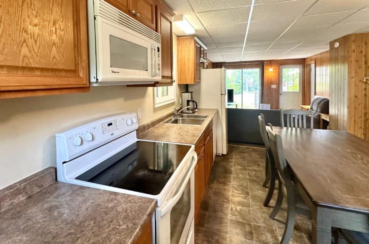 A cozy kitchen with wooden cabinets, Sis's Cottage Bathroom, bruce anchor, motel, cottage rental, 3 bedroom, cruises, tobermory